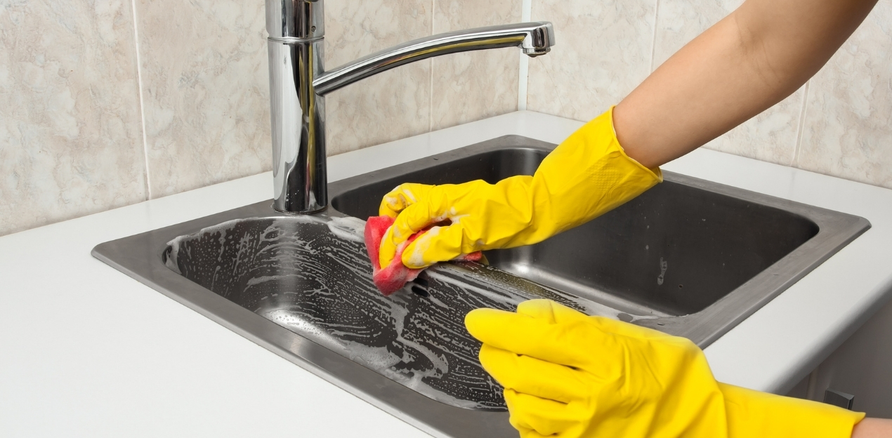 a lady cleaning her bathroom mirror 